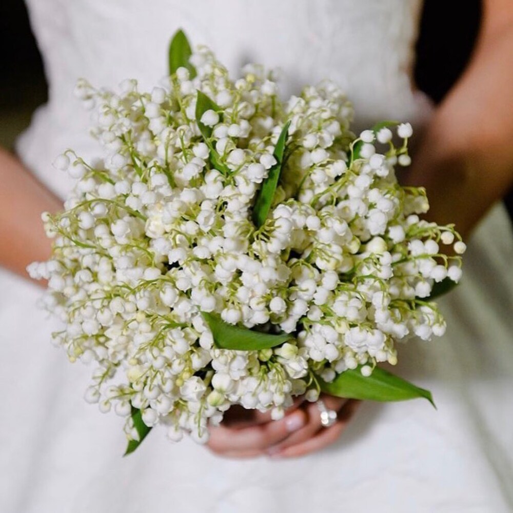 Bride holding a lily of the valley bouquet